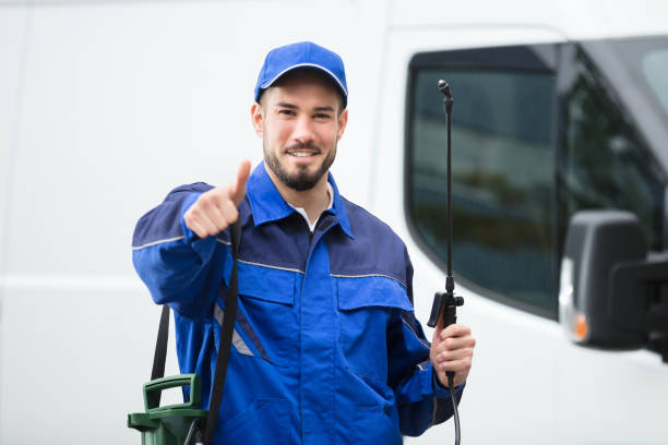 portrait of a smiling male pest control worker standing in front of vehicle portrait of a smiling male pest control worker standing in front of vehicle